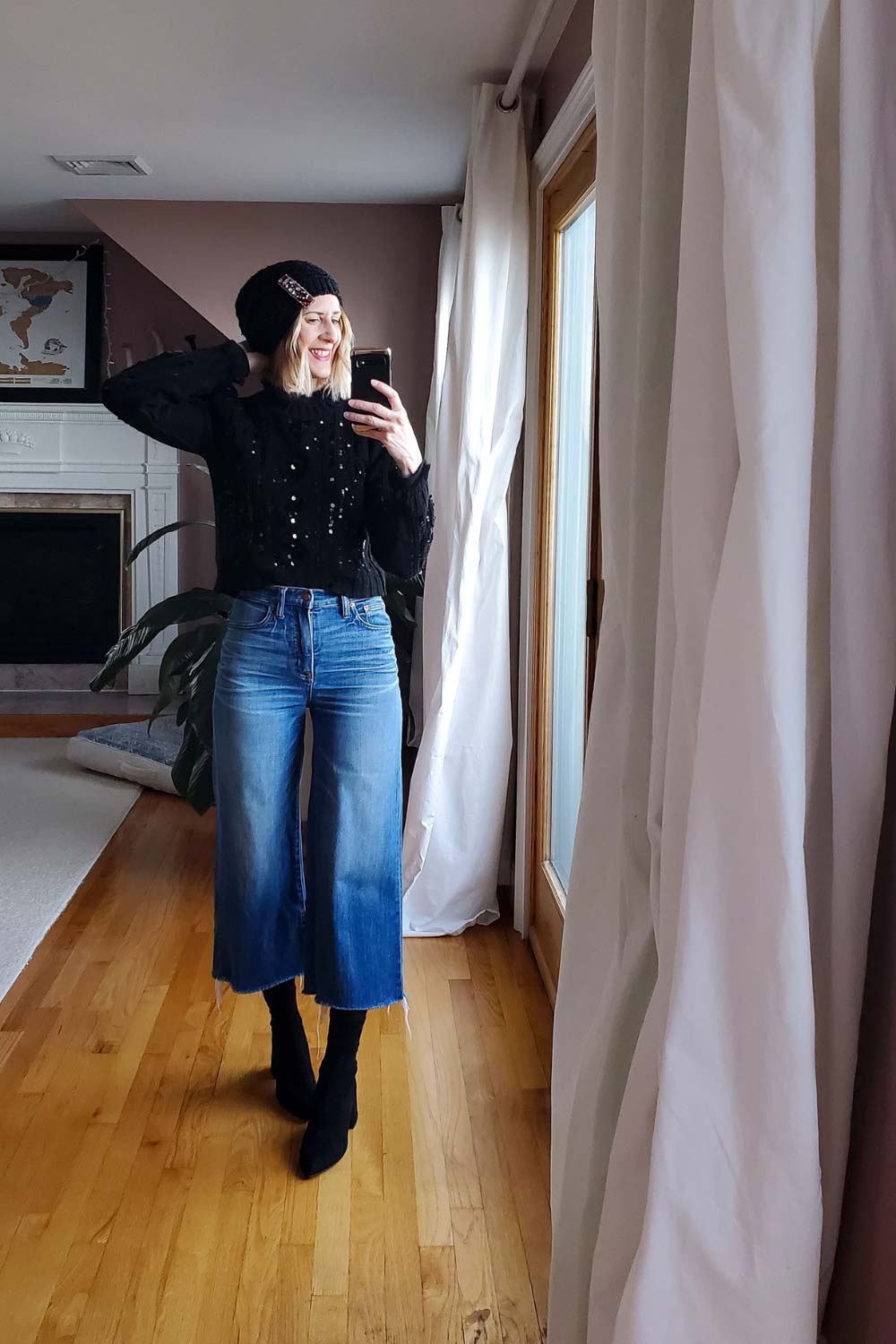 an image of a women wearing ankle boots with cropped wide leg jeans