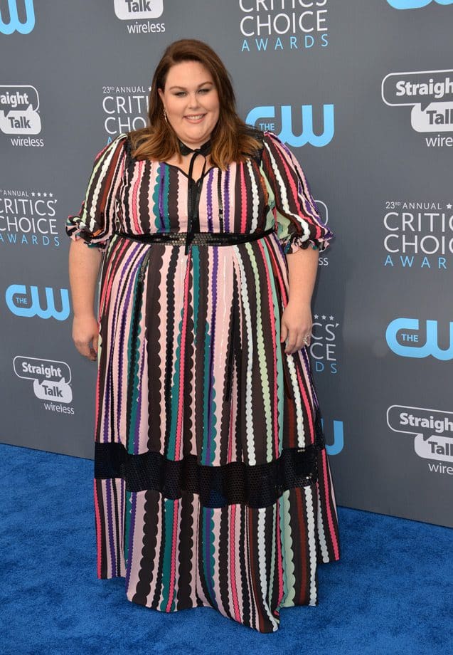 Chrissy Metz wearing a full length dress in vertical stripes