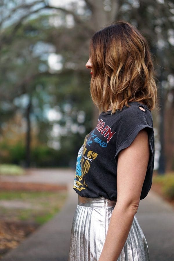 An image of a pear shaped women wearing a band tee