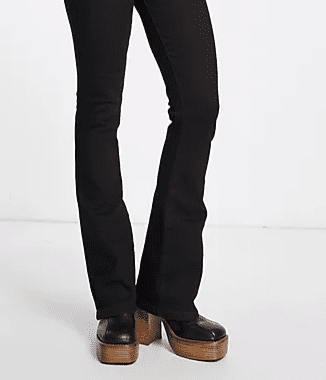 Black flare jeans worn with wooden platform ankkle boots